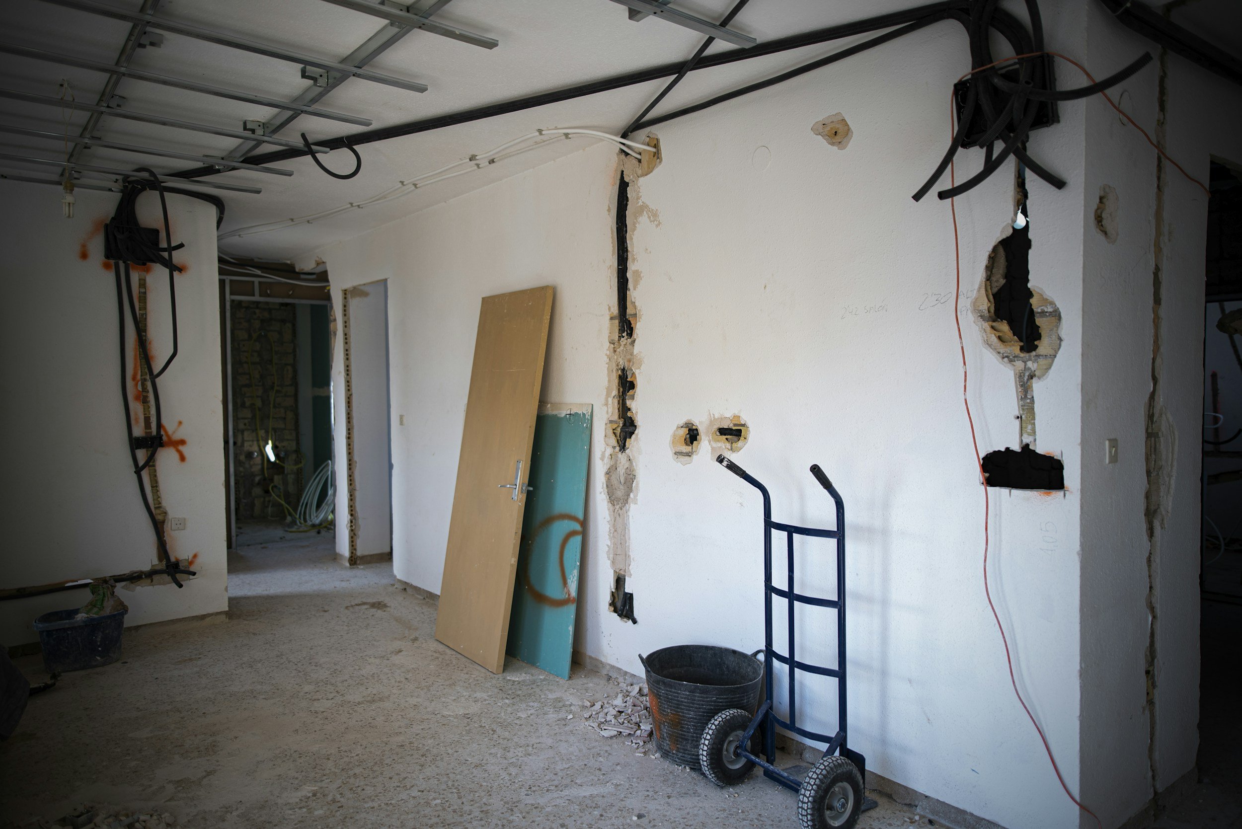 walls with holes in, chasing the electrical wires from a house re-wire project