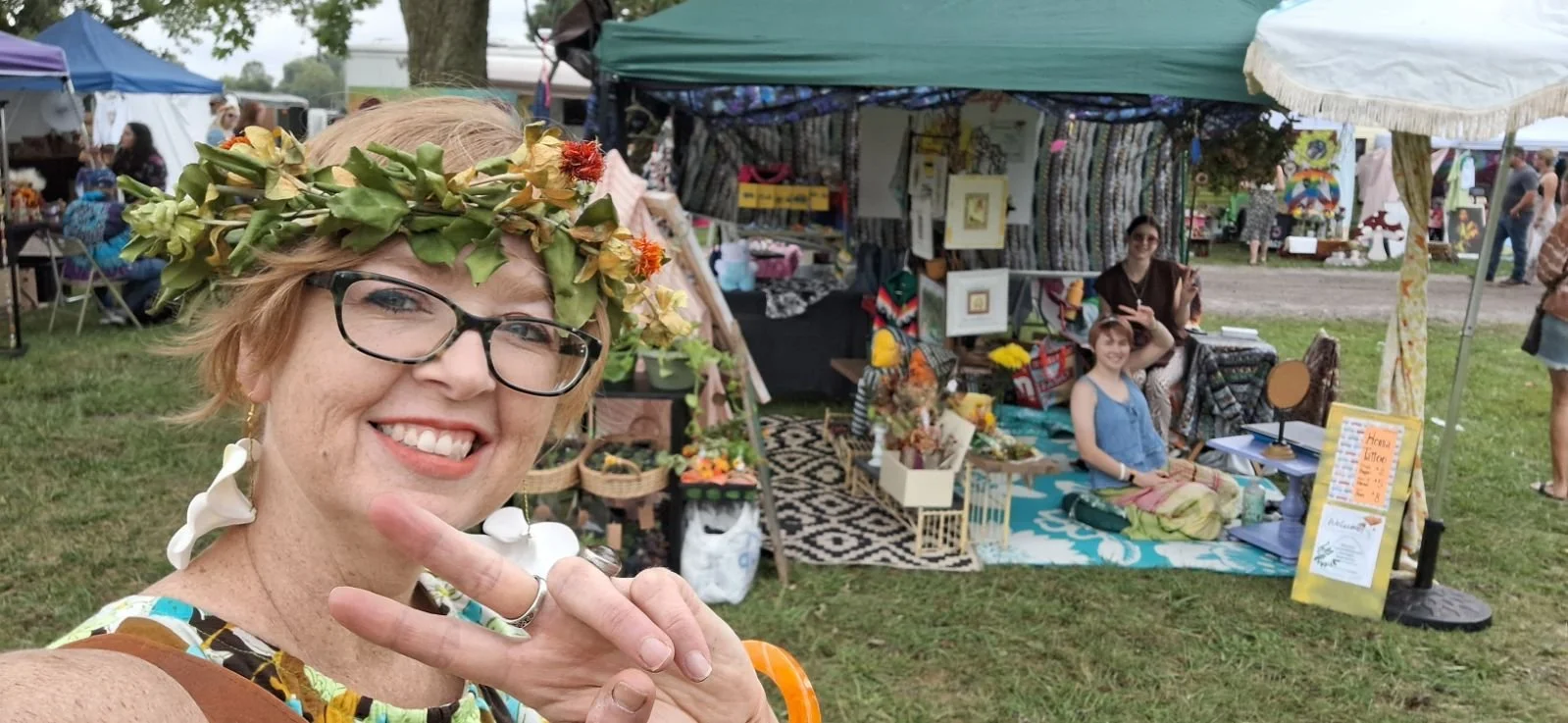 Natalie posing in front of the booth while I finish up some henna! (2024)