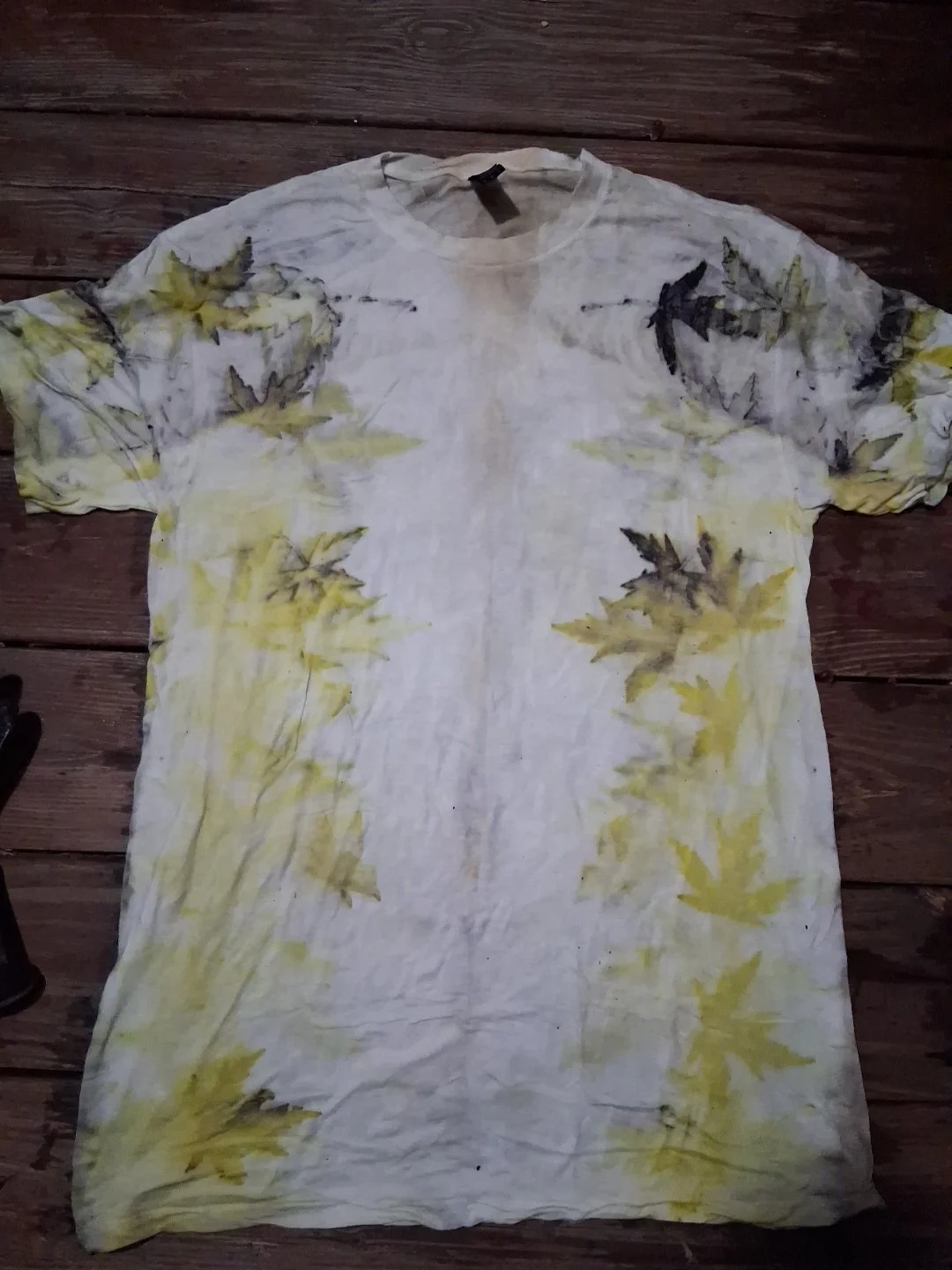 An eco printing I did using Japanese maple leaves. I wrapped the shirt around a copper wire and boiled it to get this cool effect.