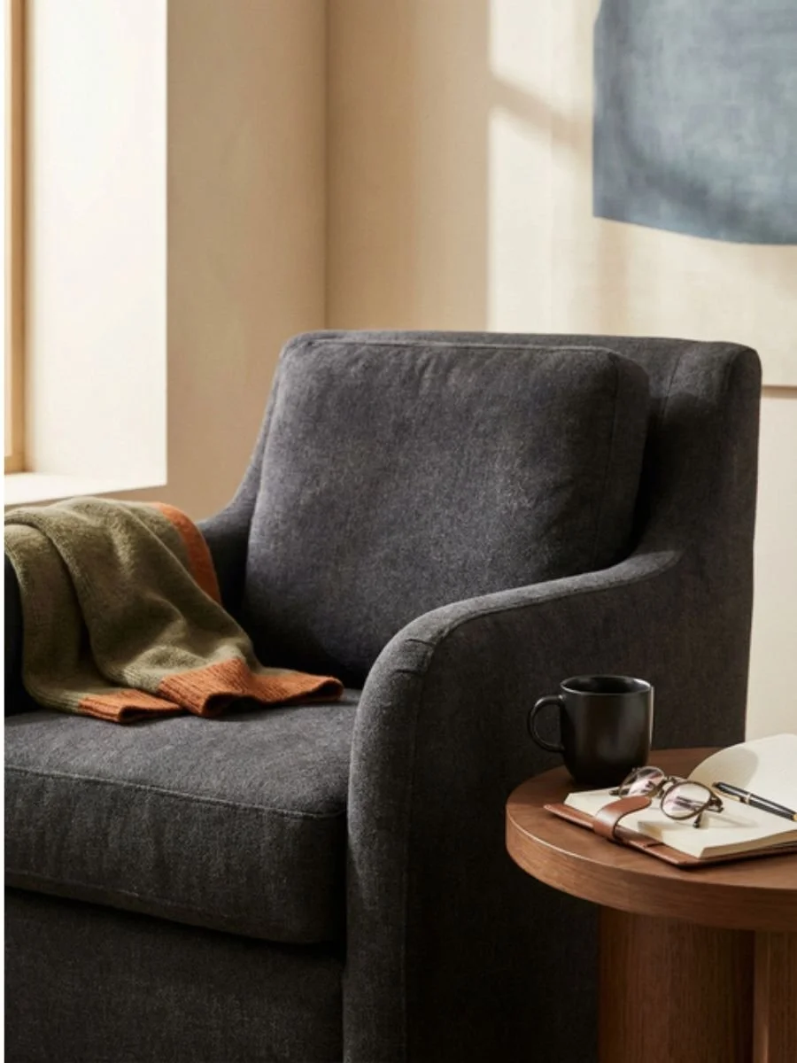 Comfortable armchair beside a window in a calm, softly lit room