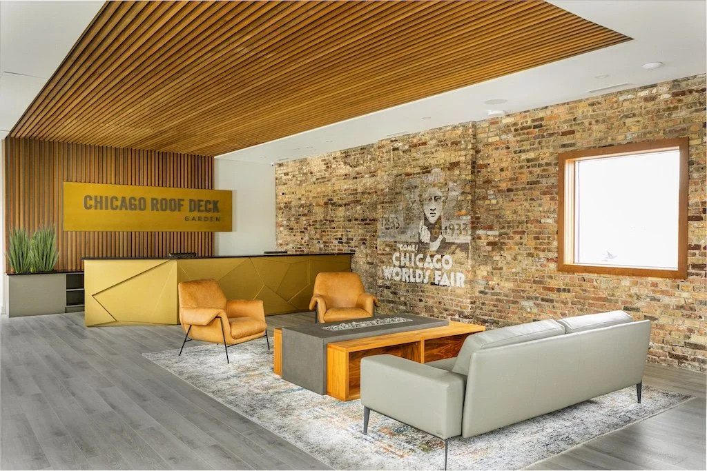 chicago-modern-corporate-office-lobby-front-desk-feature-wall-wood-accent-seating-area-brick.jpg