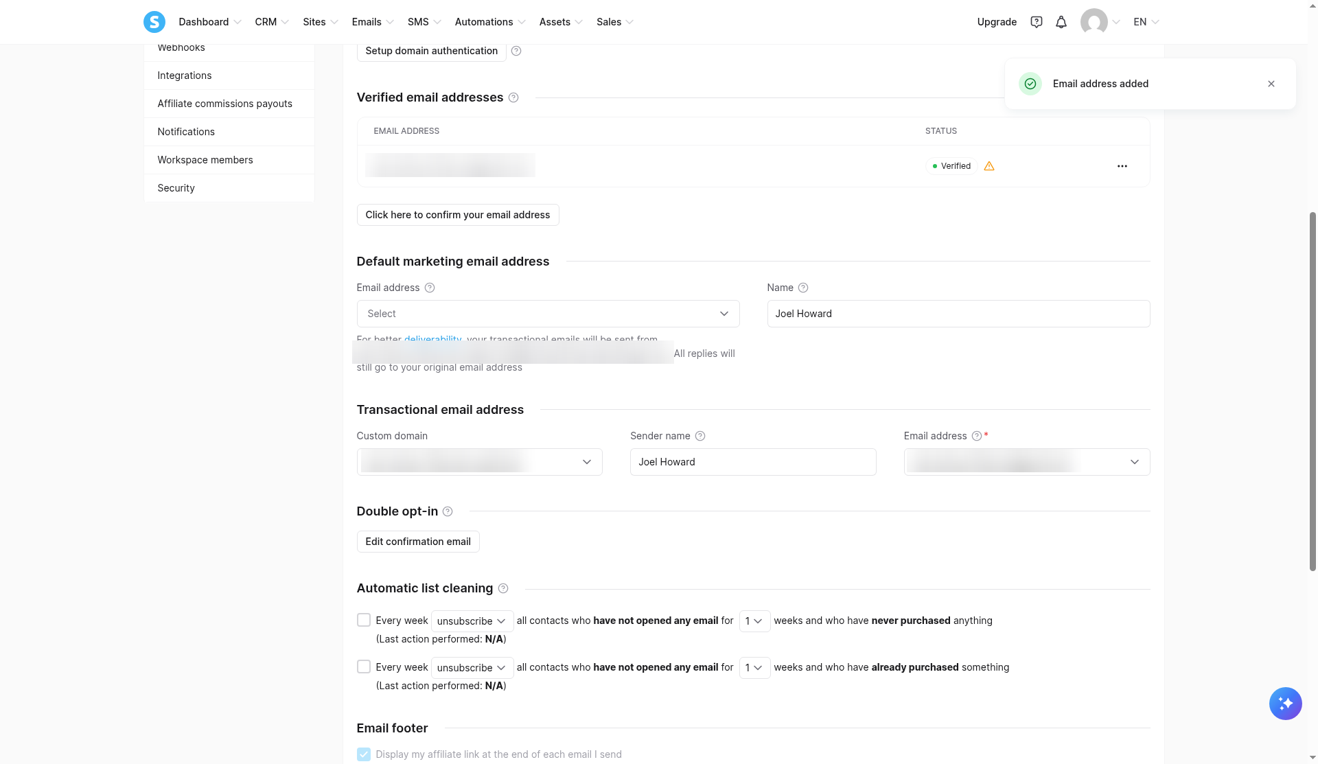 Systeme.io email settings on our free account showing a Gmail sender marked Verified with a warning icon and an empty Default marketing email address dropdown (address blurred)