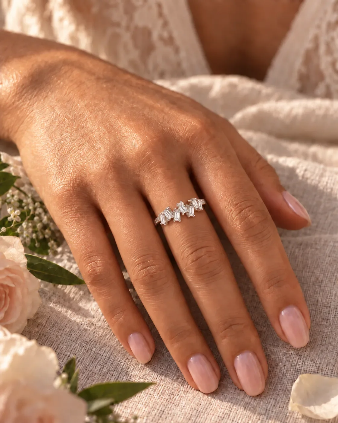 Hand wearing 18K white gold baguette diamond ring