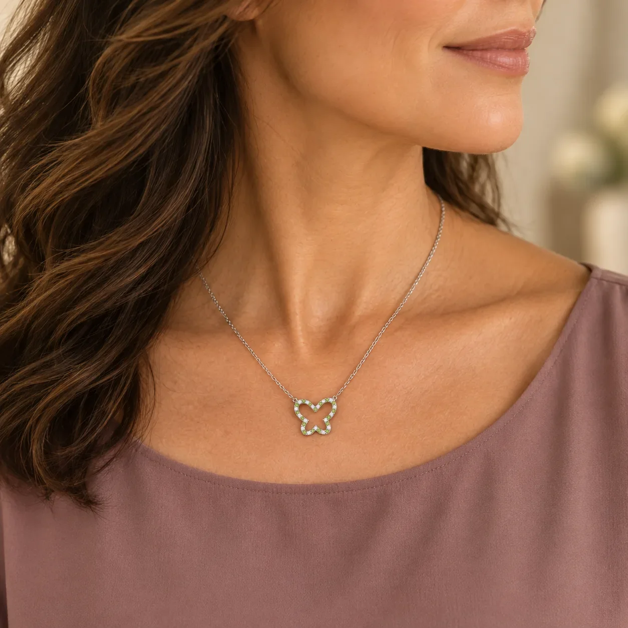 Peridot cut-out butterfly necklace worn
