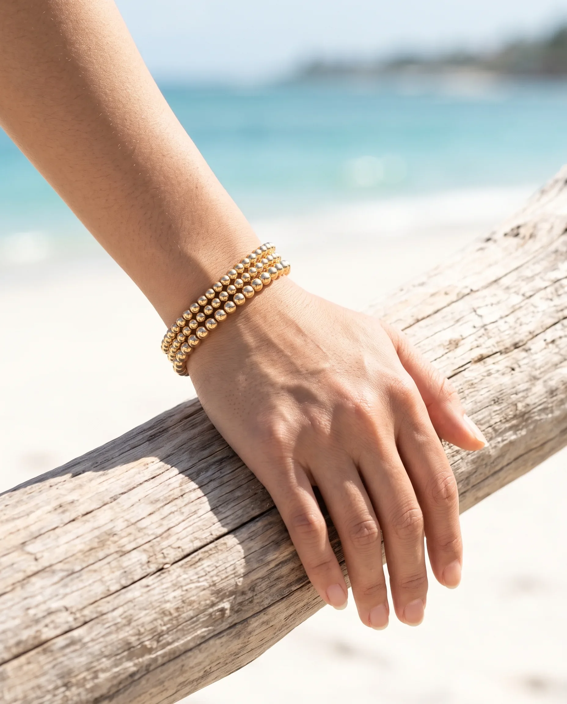 14K gold-filled bead bracelet worn on wrist, layered