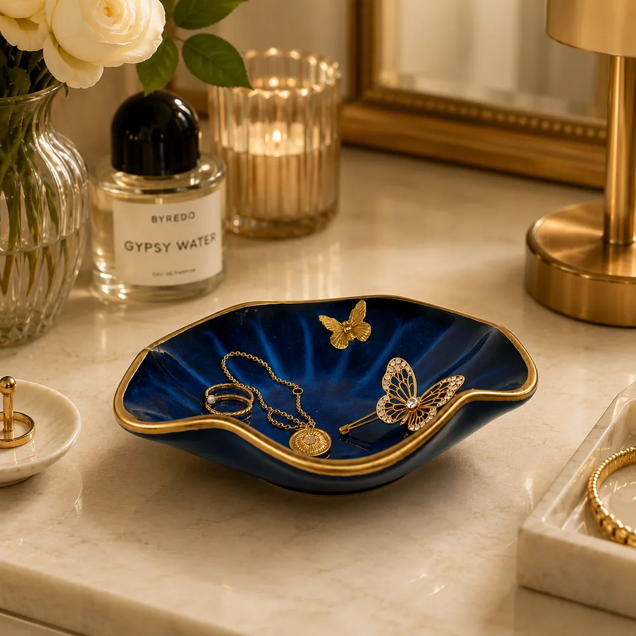 Navy butterfly jewelry dish styled on vanity