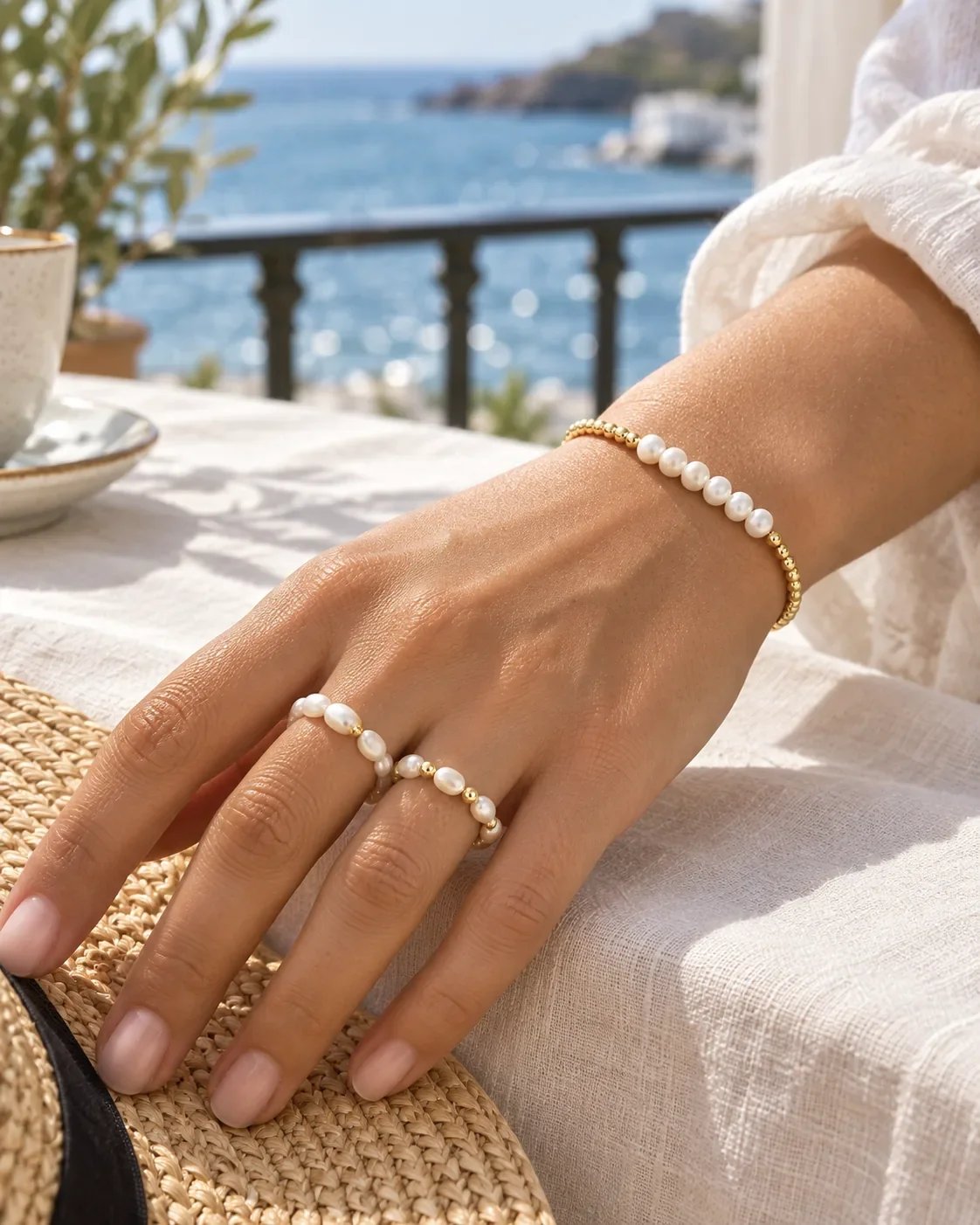 Freshwater pearl and gold bead stretch ring worn on hand