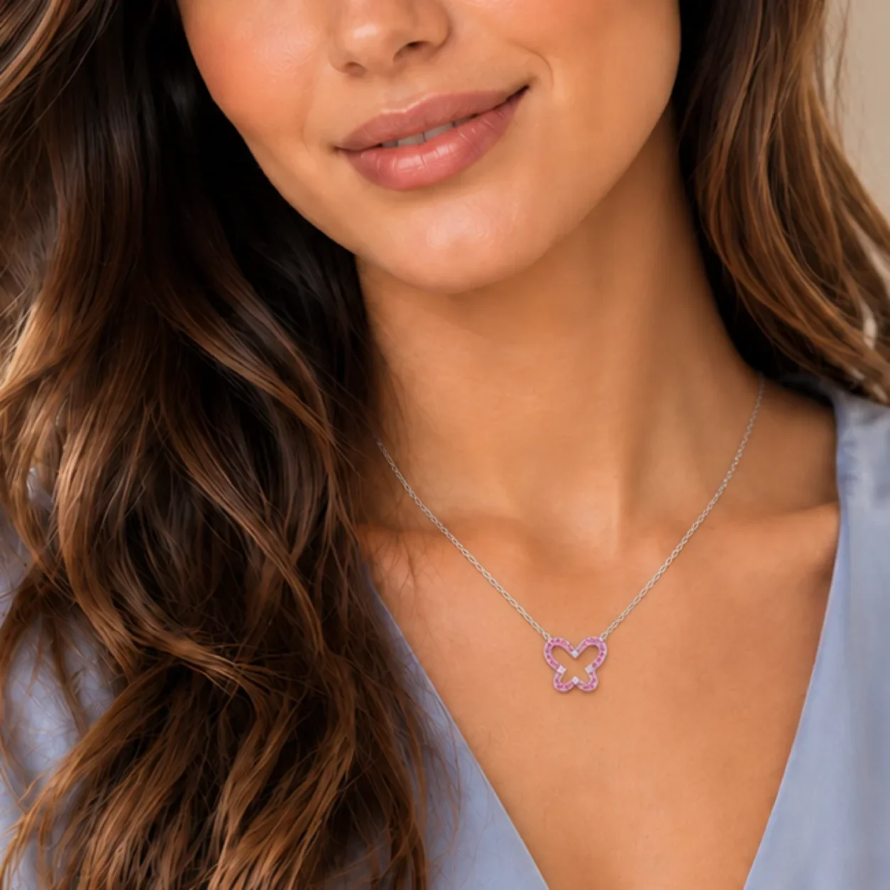 Pink tourmaline cut-out butterfly necklace worn