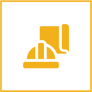 Construction helmet and blueprint on a dark background.
