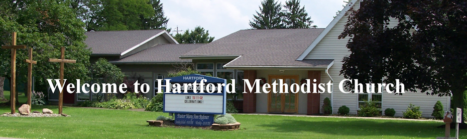 Exterior of Hartford Methodist Church with welcoming sign and well-maintained lawn.