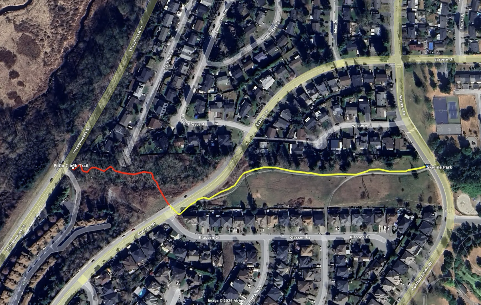 An aerial view of a suburban neighborhood with streets, houses, and a park with tennis courts. There are two marked trail routes: a red trail labeled PoCo Climb Trail and a yellow trail, both running through the area.