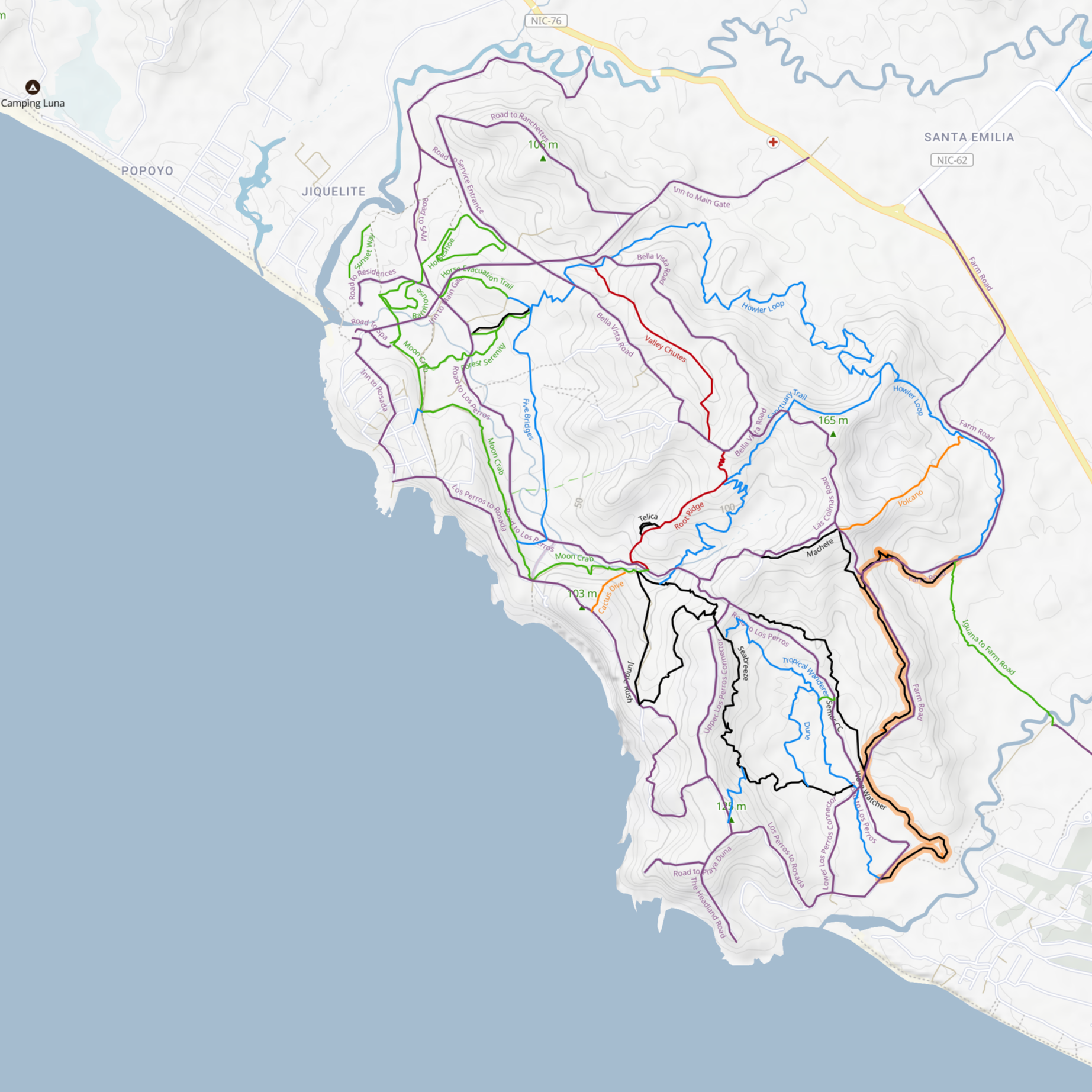 A detailed topographic map showing various hiking trails and roads near the coast in a region with forests and water bodies. Trails are marked with different colors and labels, and elevation contours are visible.