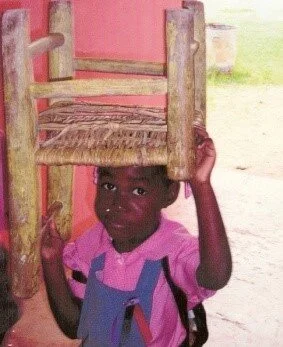 Boy with chair.