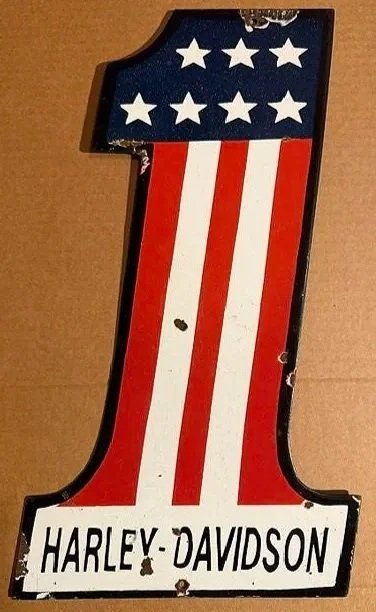 Vintage Harley-Davidson sign shaped like the number one with the American flag pattern.