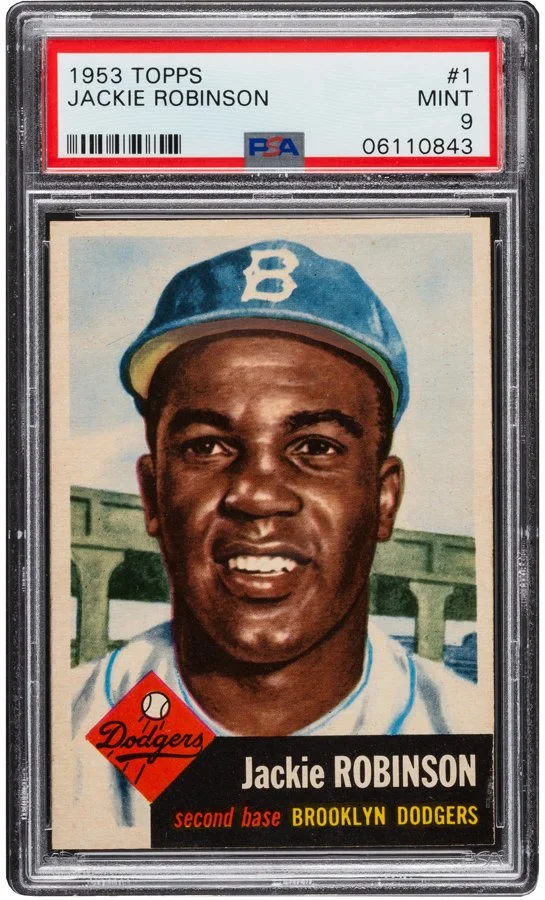 1953 Topps Jackie Robinson baseball card graded PSA 9 encapsulated in a plastic case, featuring a portrait of Jackie Robinson wearing a Brooklyn Dodgers cap, with a bridge in the background and Dodgers logo in the lower left corner.
