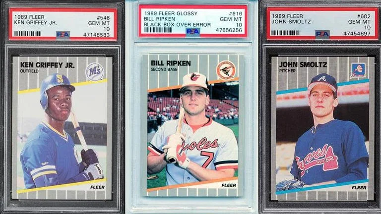 Three baseball trading cards featuring Ken Griffey Jr., Bill Ripken, and John Smoltz, each graded and encapsulated in protective cases.