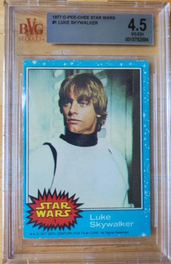 A graded 1977 Star Wars Han Solo card in a protective case with a 4.5 grade from BVG, featuring a photo of Luke Skywalker in his white outfit.