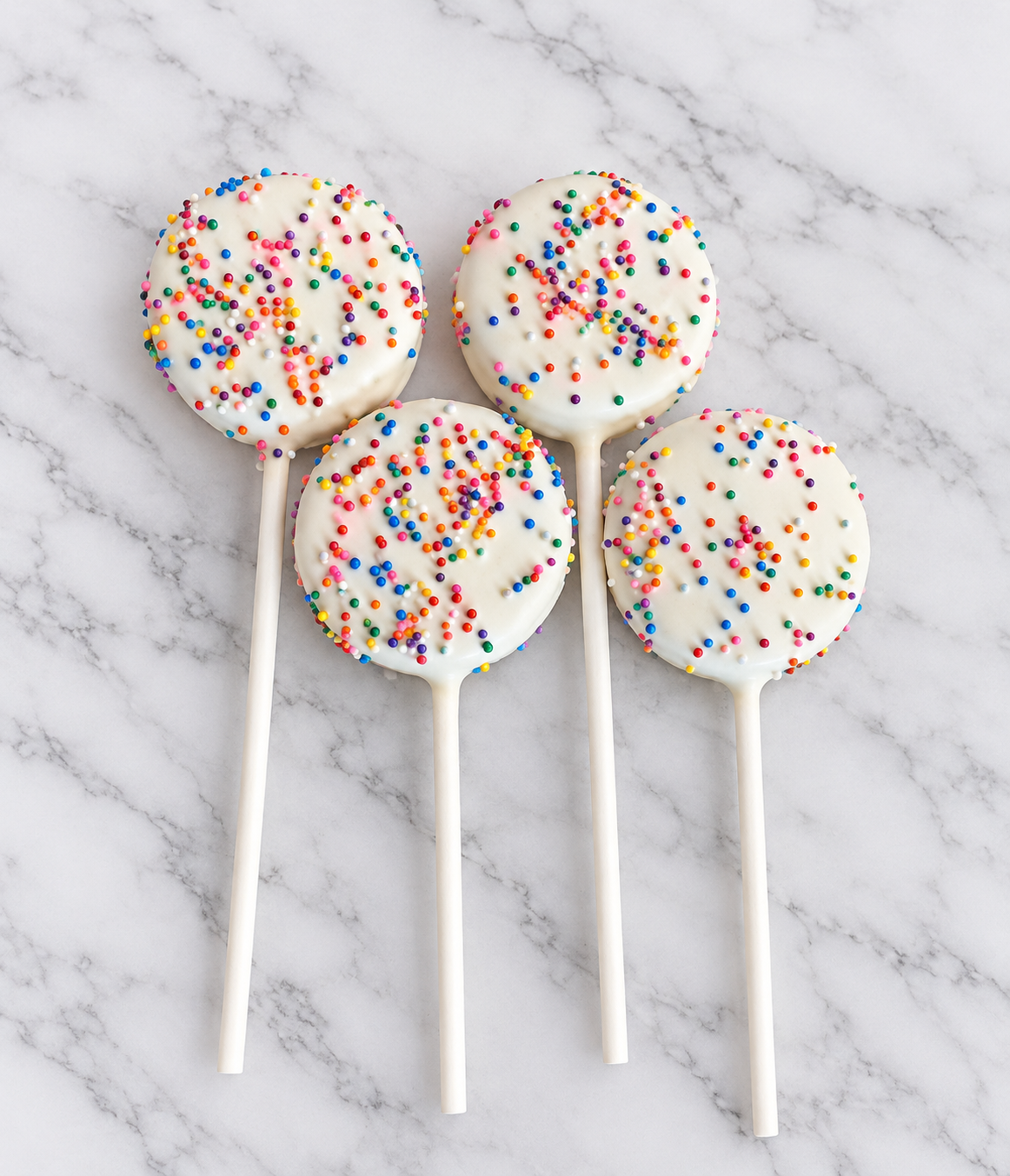 Rainbow Sprinkle Cake Pops on Marble.png