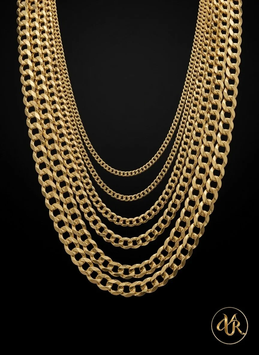 Multiple gold chains of varying thicknesses and designs hanging against a black background.