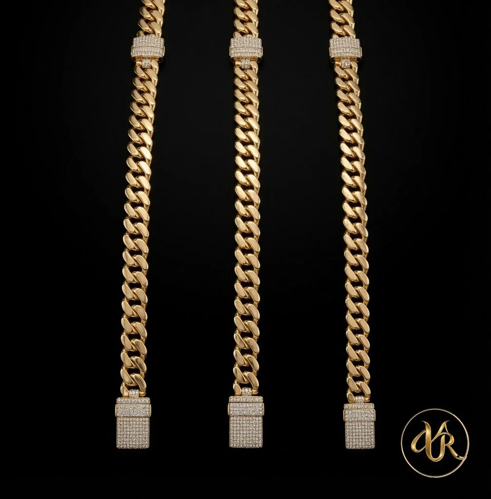 Three gold chains with diamond-encrusted clasps on a black background, with a gold monogram logo at the bottom right corner.