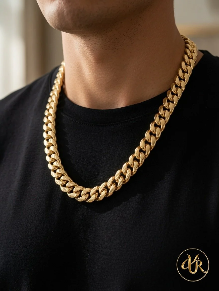 Close-up of a person's neck and chest wearing a thick gold chain necklace and black shirt.