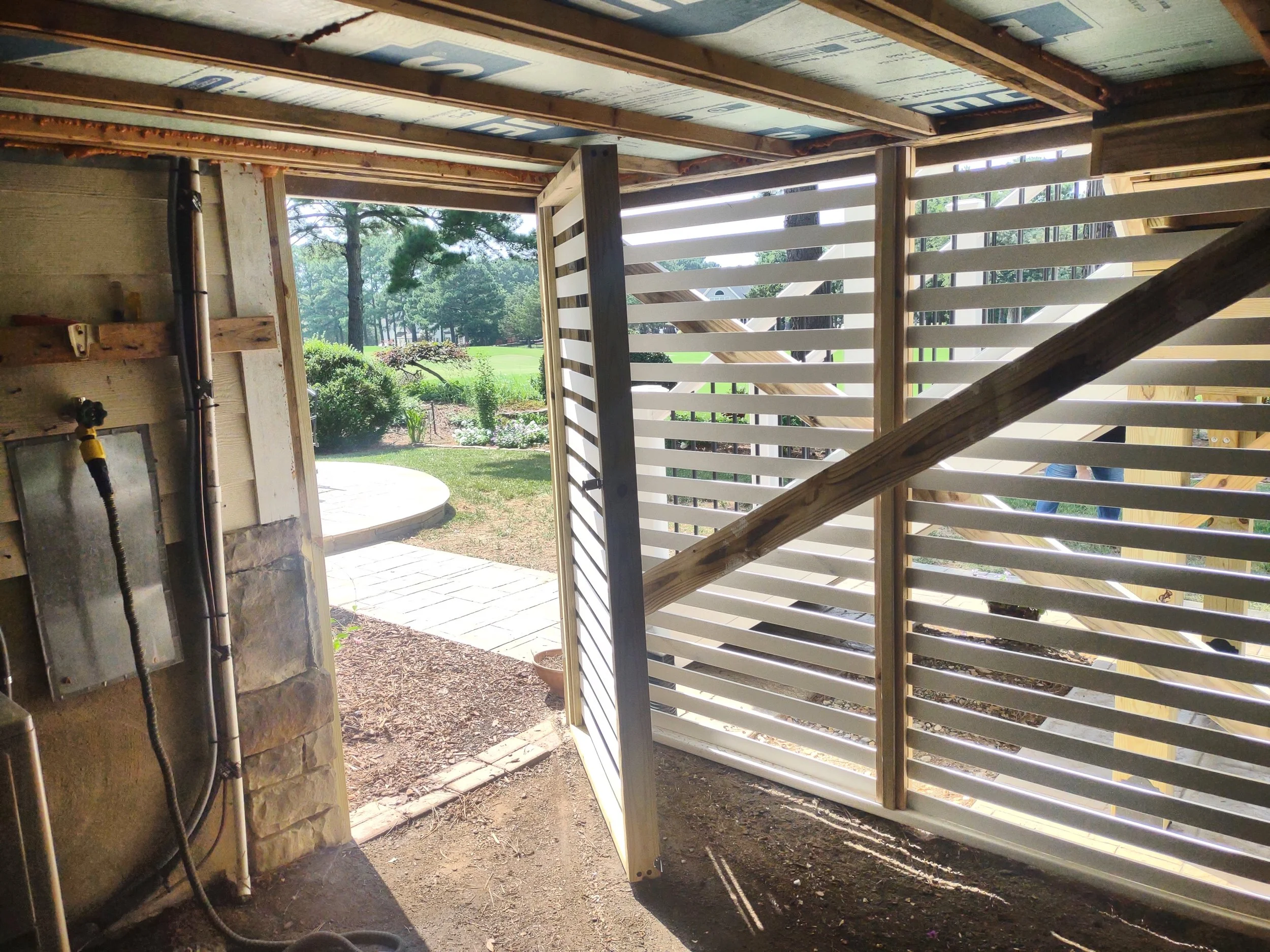 This is custom made expanded vinyl lattice enclosing the garden shed beneath the sunroom. The bottom frame board on the ground is  made from an Owens Corning product that is made from 100 polymer (HDPE) and will stand up to the elements and moisture 