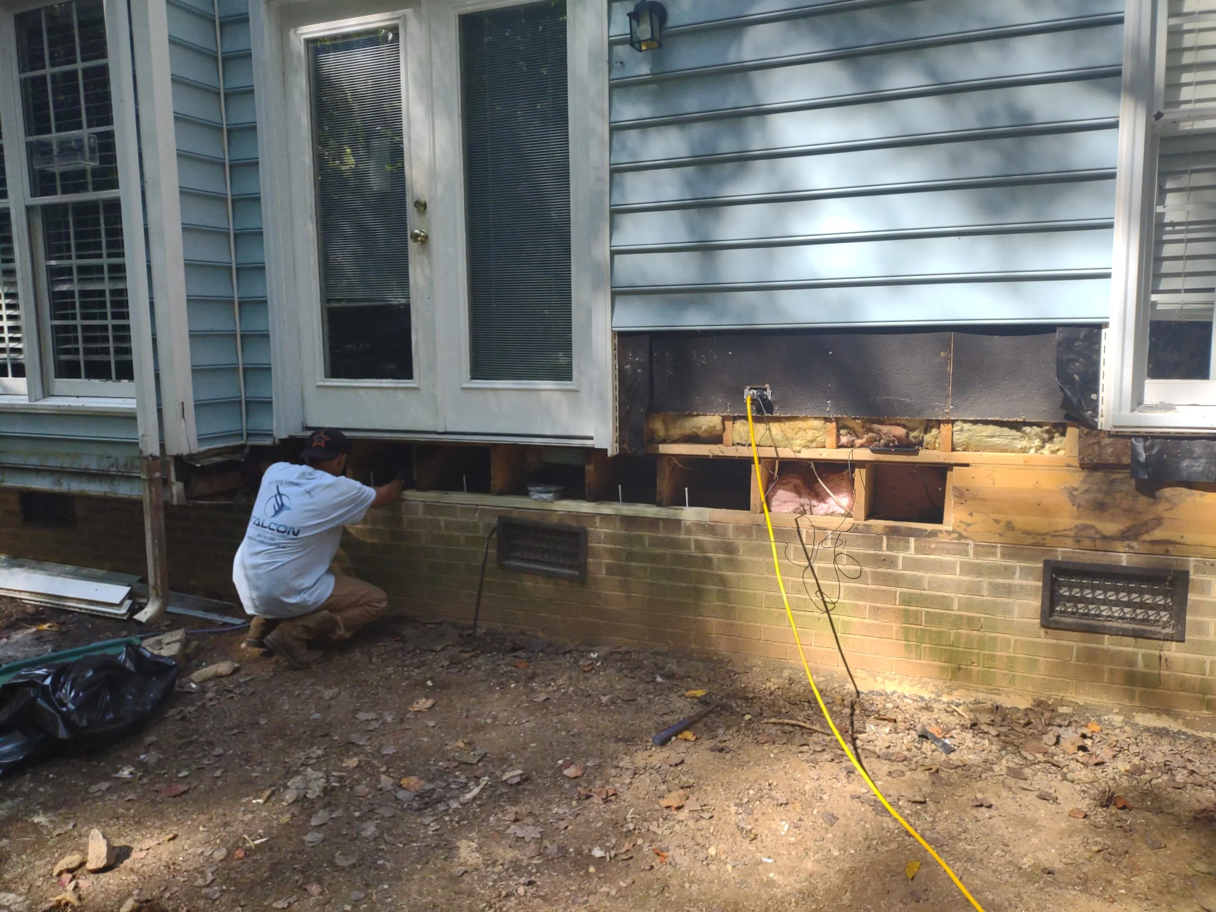 The home is supported from the crawlspace with a temporary beam while structural repairs are being performed.