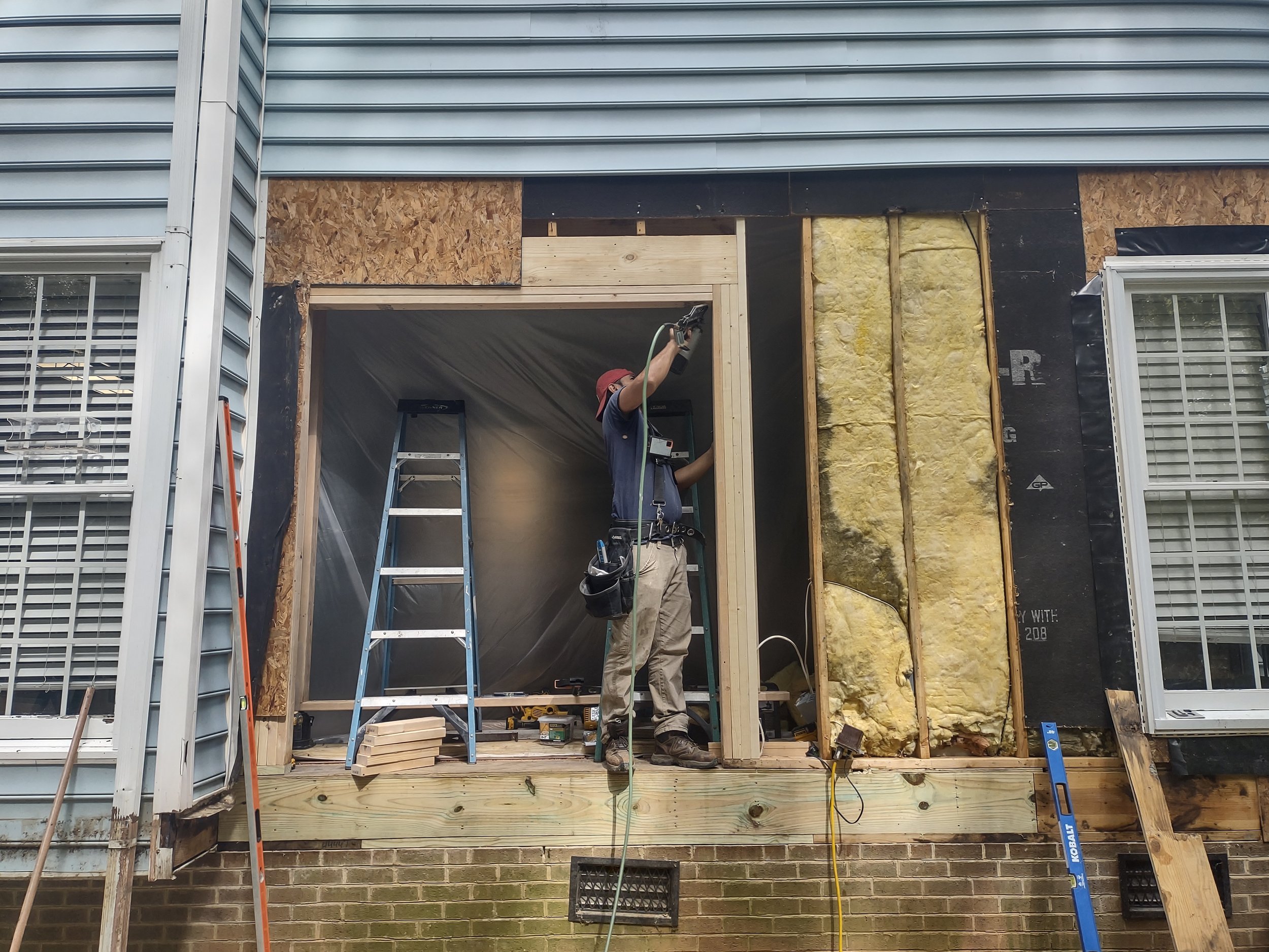 The doorway was expanded to accept the lager 72 inch wide French door assembly. There is a temporary wall constructed inside the home directly on top of the temporary beam location in the crawlspace to support the second floor during the new framing 