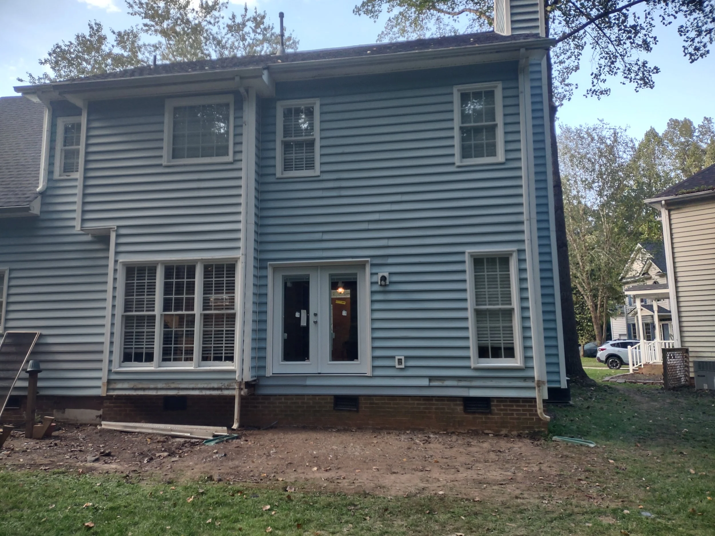 The back of the house has been temporarily resided  after structural repairs and improvements while the Three Season Room materials are on order.