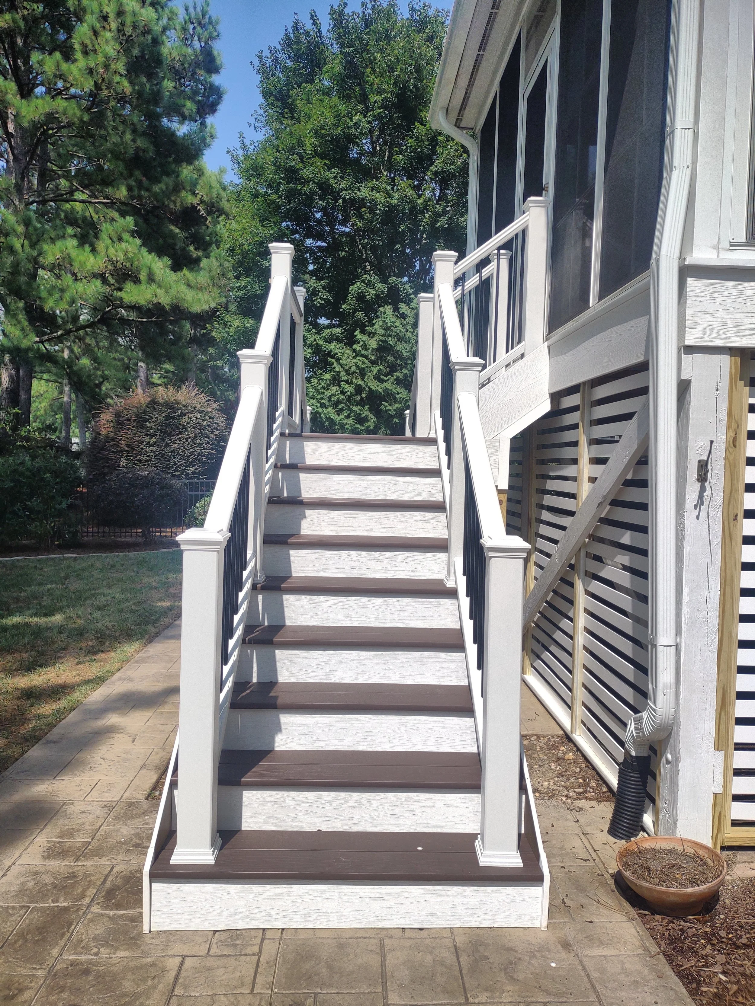 Premium dual staircase build with TimberTech treads and Trex railing. The decking and treads are fastened using TimberTech's hidden fastener system.