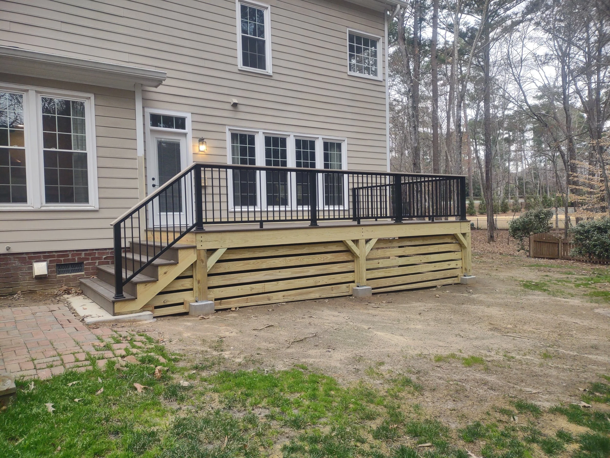 Custom deck with Timbertech PVC decking and railing and built with C.S. Consulting features