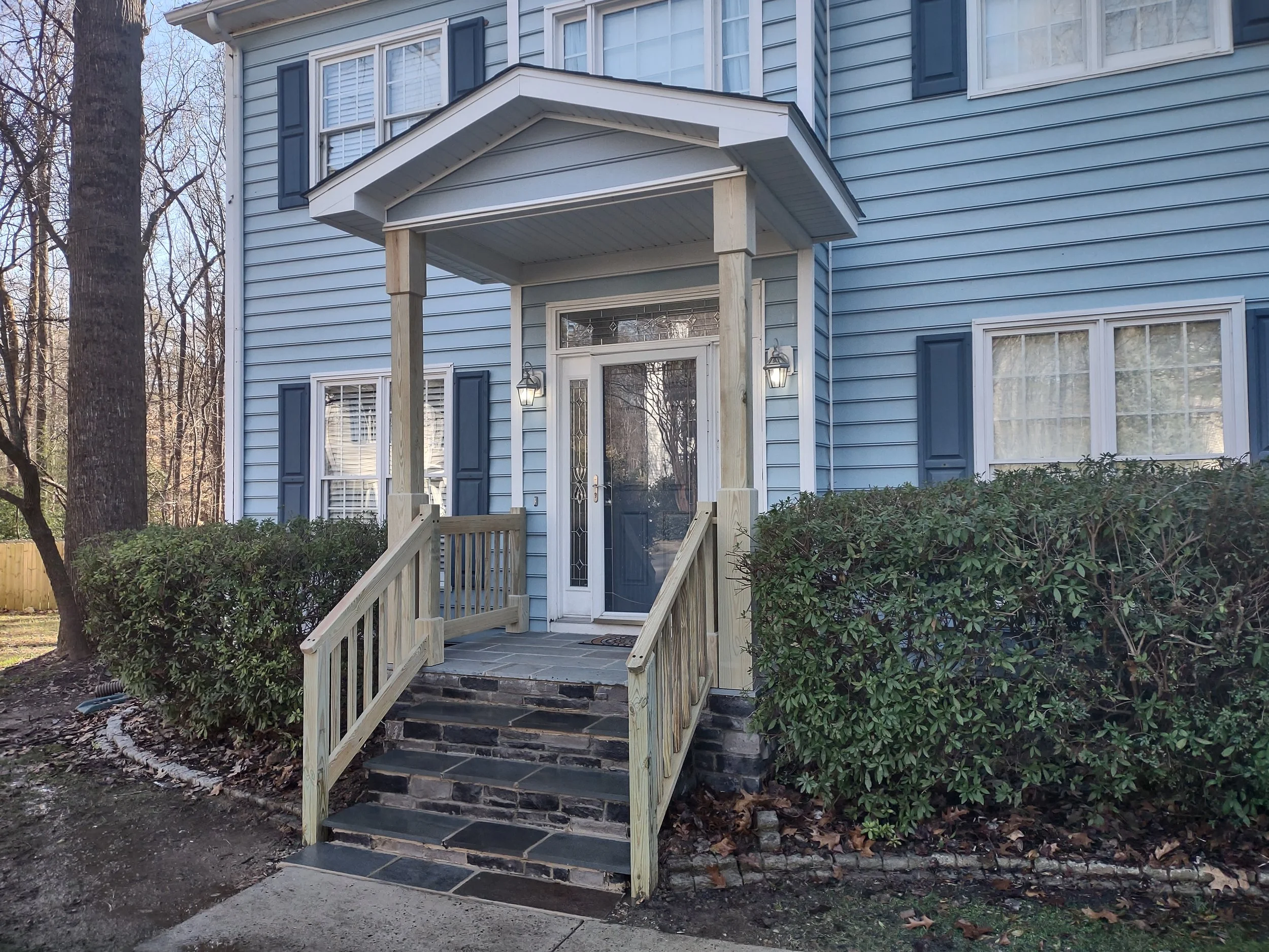 Front porch cover and railing made of premium kiln dried lumber