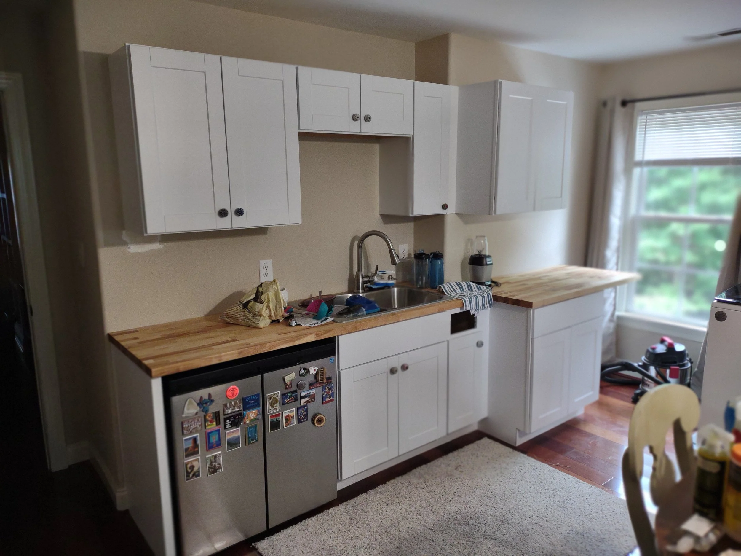 Kitchenette and laundry added to above garage bonus room to create and efficiency living area.