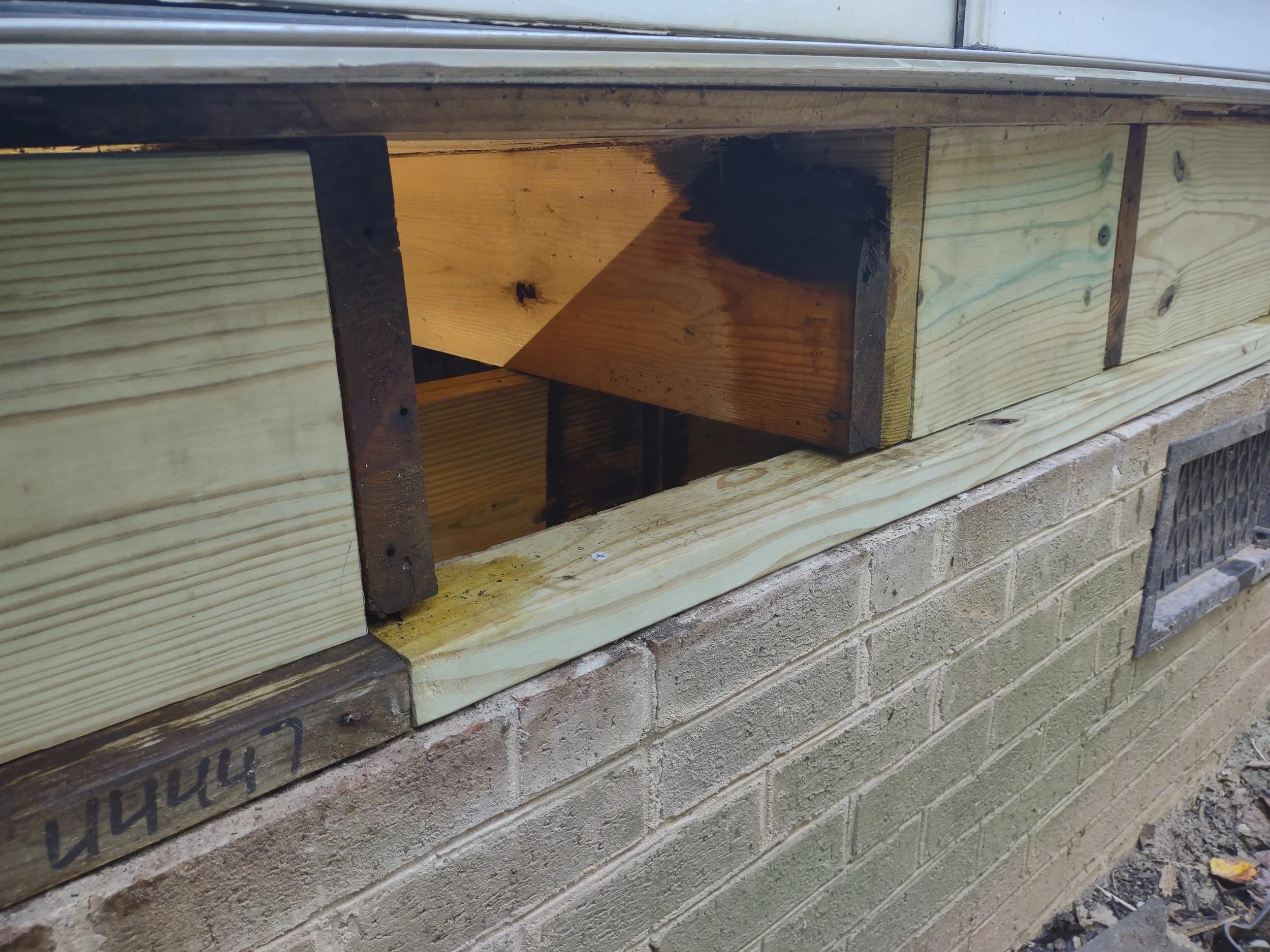 A new sill plate is installed in the required areas and blocking is added for further support between existing joists. This is a big improvement over the original construction. A copper oil wood preservative was added to the ends of the existing jois