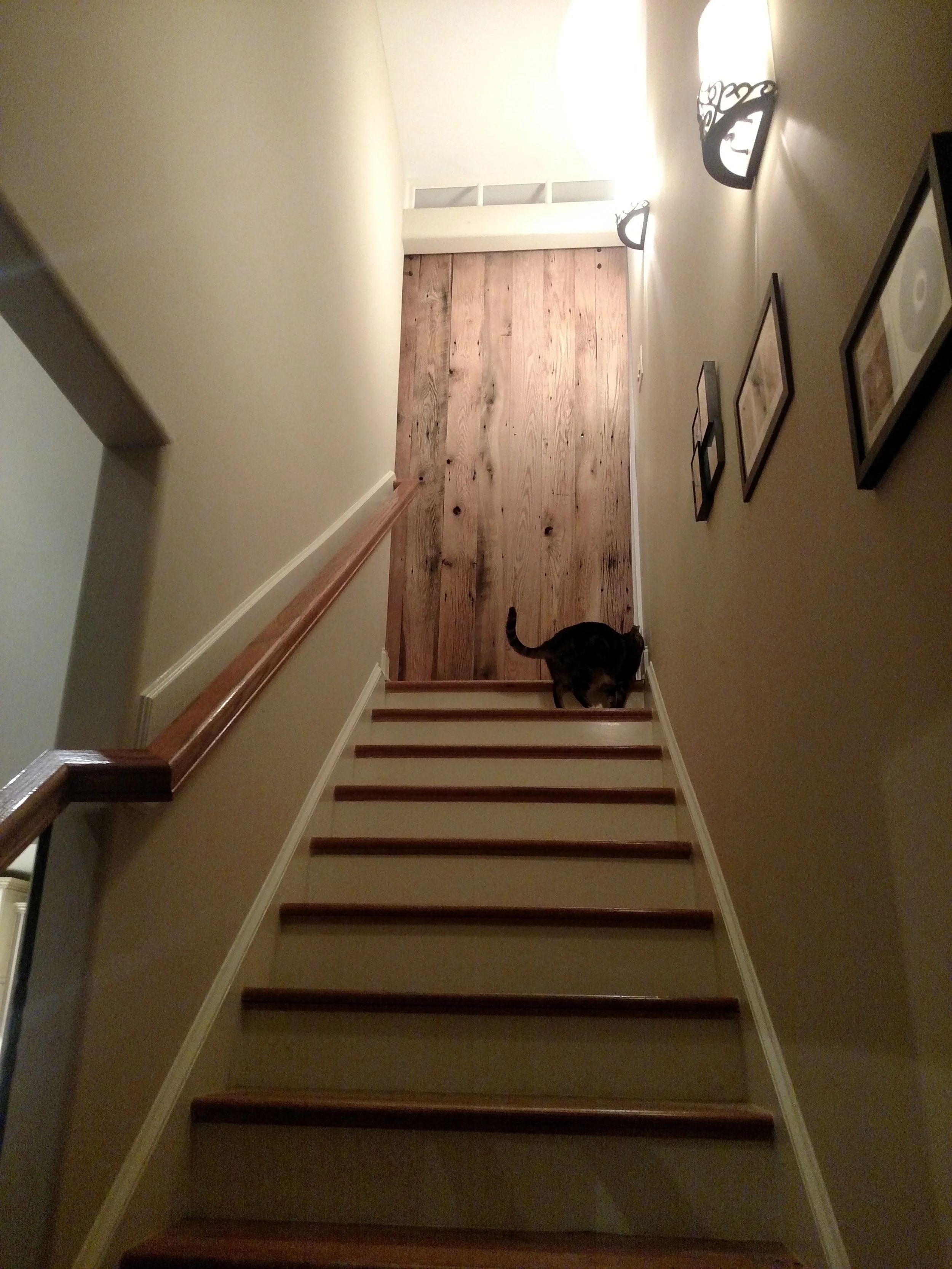 Custom 100+ year old barn wood used to create a custom heavy barn door and French door build out to promote privacy between floors
