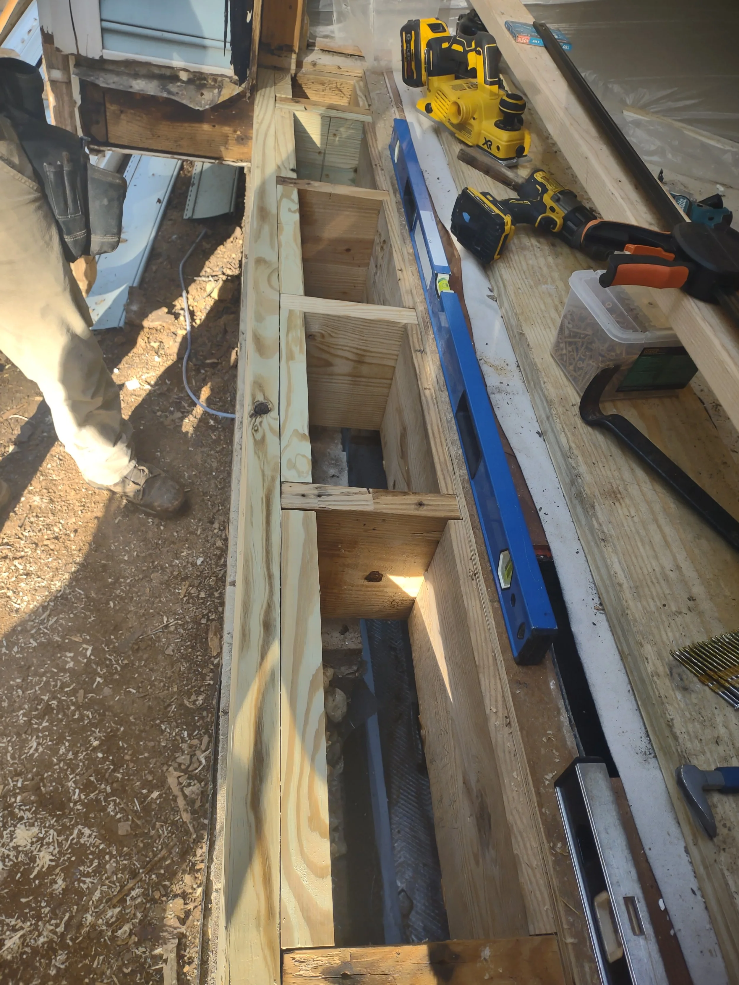 The new band joist and the added blocking can be seen from above with the damaged subfloor removed. This is helpful in many ways to the structures strength and integrity
