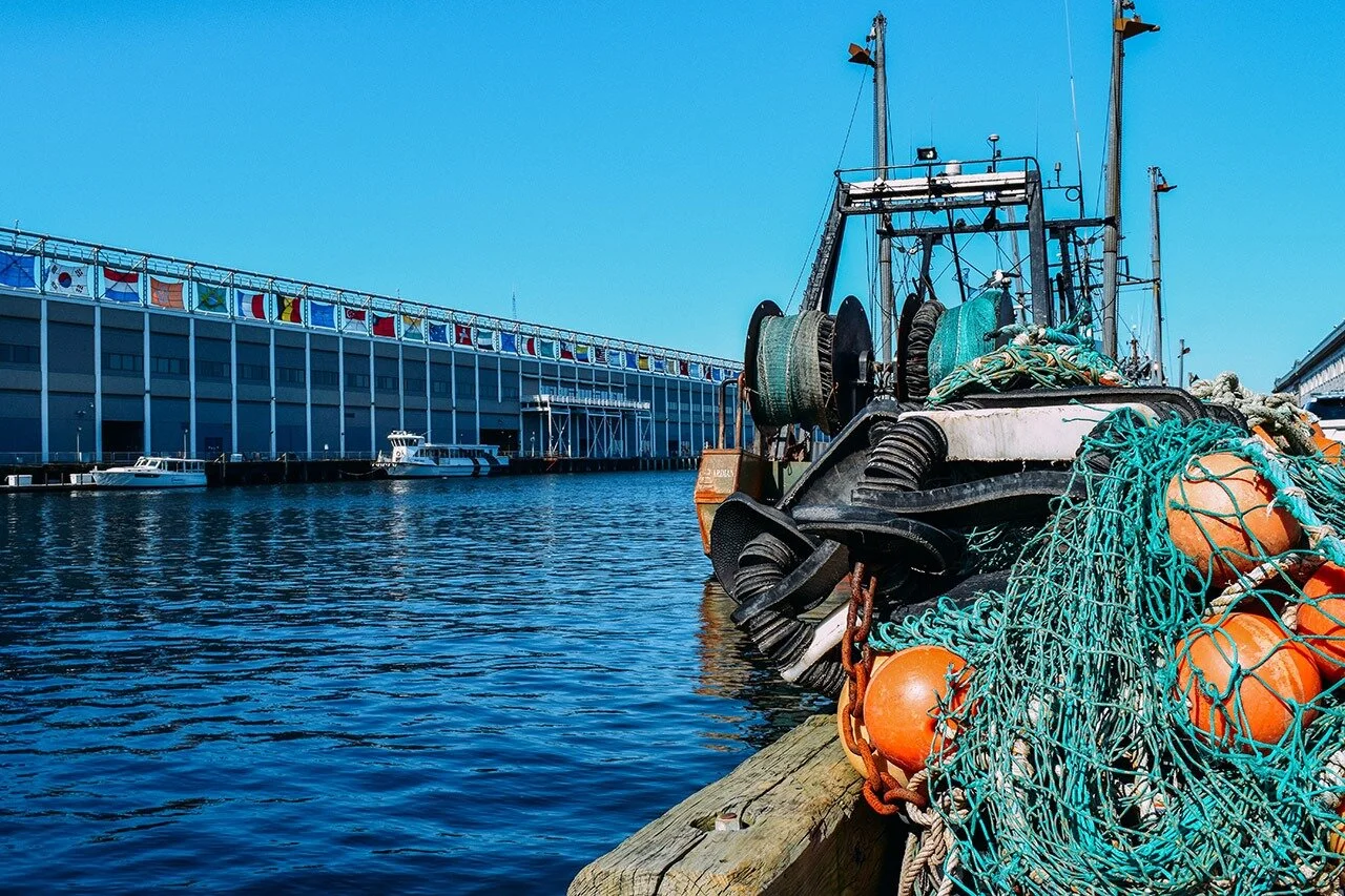  At the end of the workday, in the early afternoon, the fishermen pack up their boats and go home. While the rest of the Seaport is only part way through their days, the fishermen are ending theirs. 