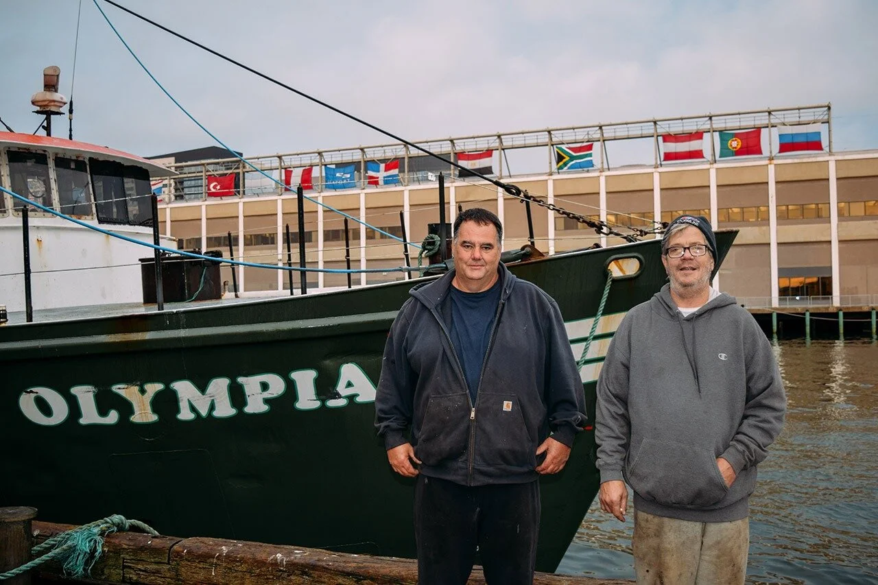  Mike Walsh (left), and Steven Broy, Captain of the Olympia, have seen the transformation of the Seaport throughout their careers. They started when the fishing industry in Boston was booming, but now cling to the hope that they will be able to conti