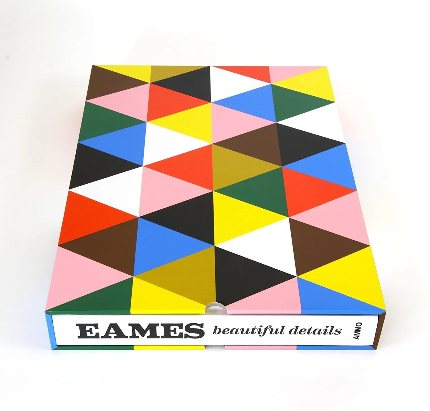A colorful geometric patterned box with the word 'EAMES' and 'beautiful details' written on the side, placed on a white surface.