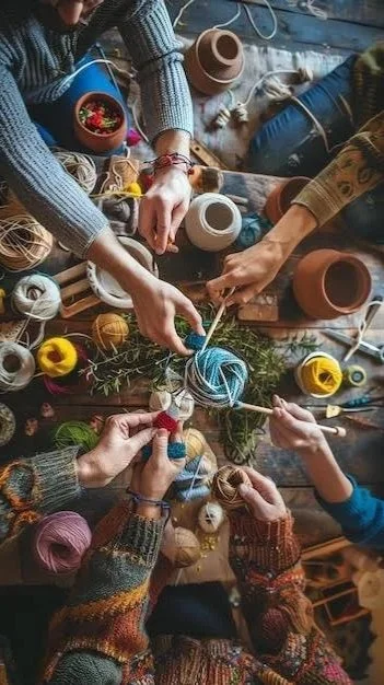 People knitting and crocheting with colorful yarn, surrounded by various balls and skeins of yarn on a wooden table.