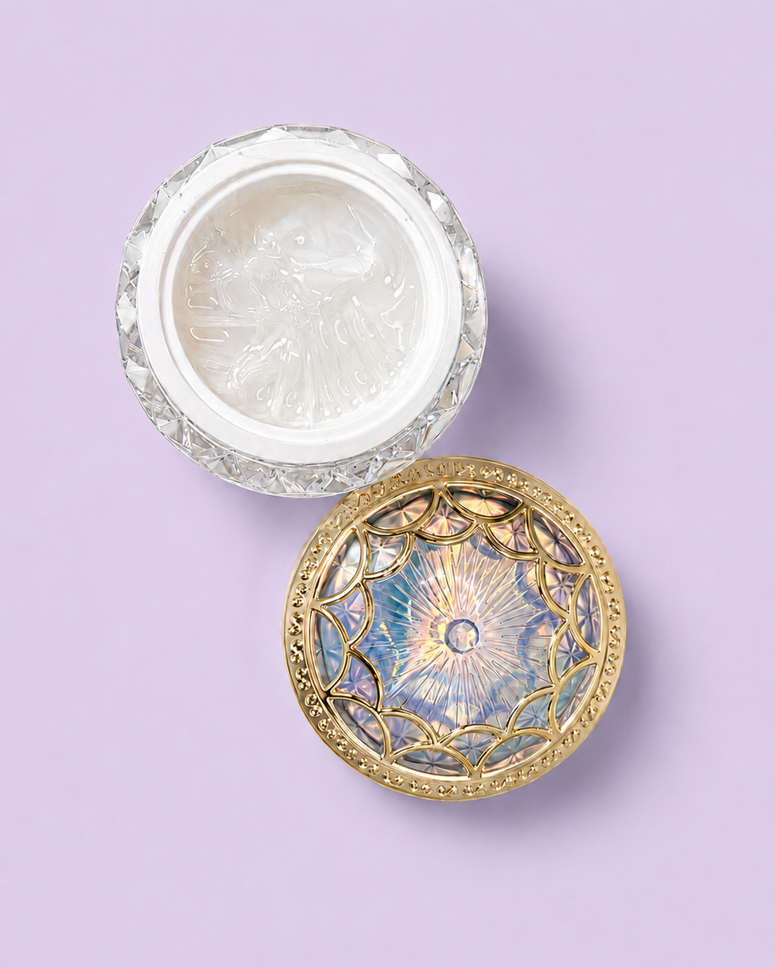 An ornate crystal container with a gold lid on a light purple background.