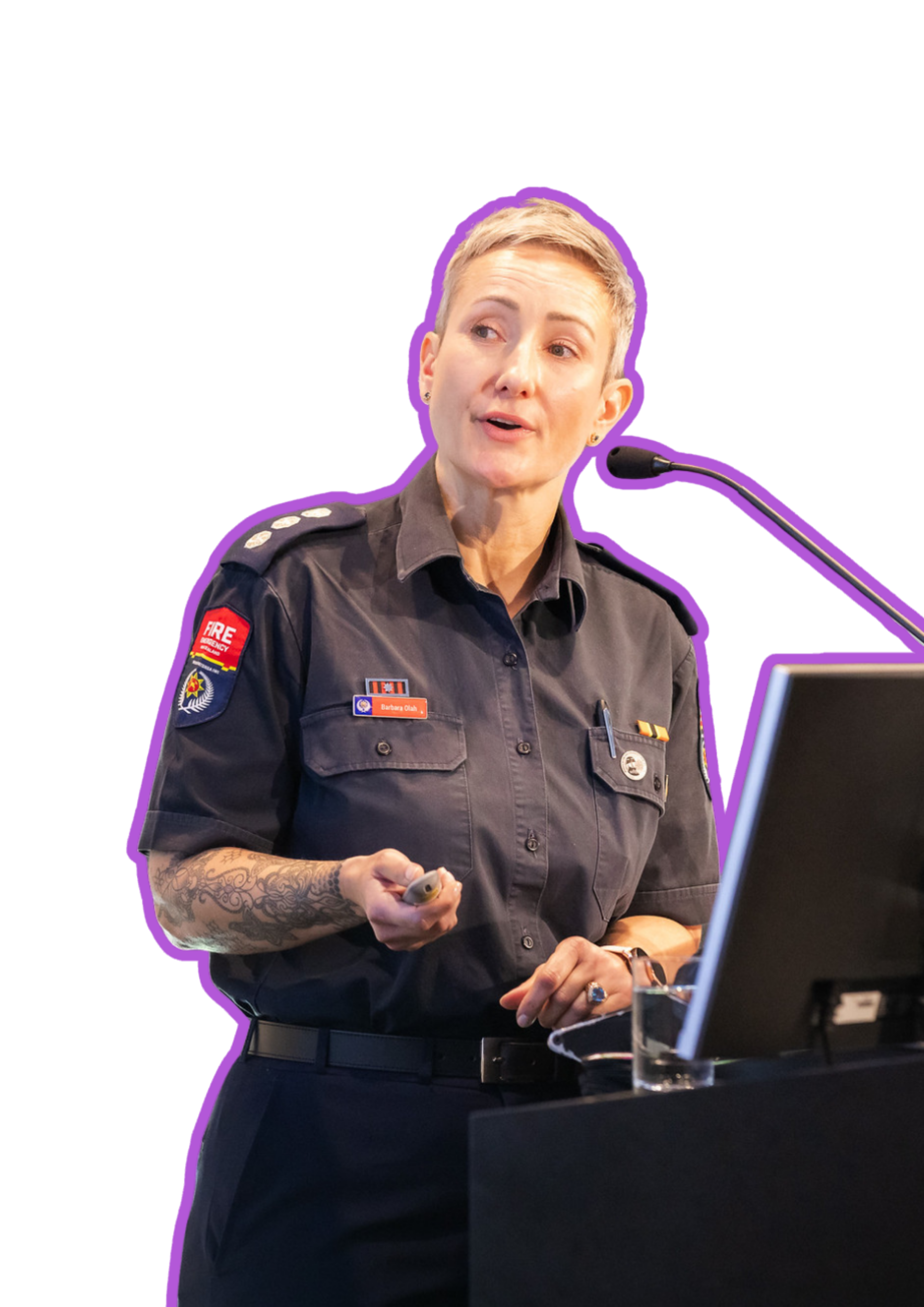 A woman in a firefighter uniform giving a presentation at a conference or meeting.