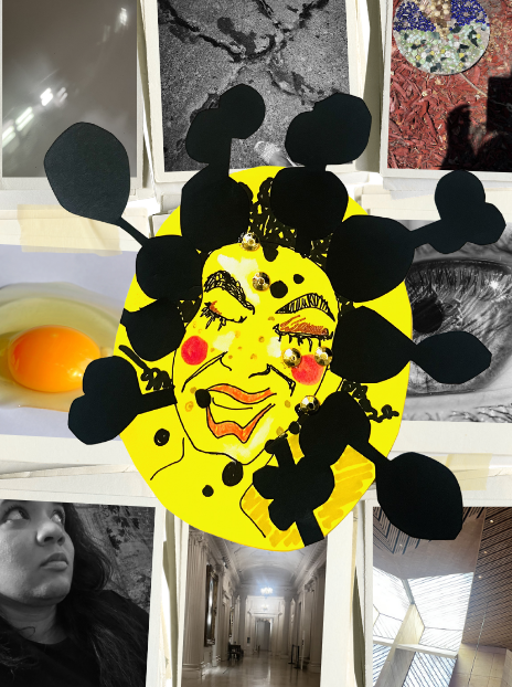 A yellow paper plate with a hand-drawn smiling face and closed eyes, decorated with black paper cutouts resembling hair and hair accessories, placed on a table with various other items including photographs and textured surfaces.