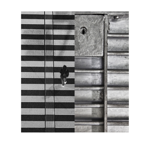 Connect weird things: Bird's-eye view of a person walking across a crosswalk with black and white stripes, adjacent to a concrete sidewalk and metallic surface.