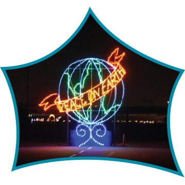 Illuminated globe with a banner reading 'STUDENT' and a rocket above it, displayed outdoors at night.