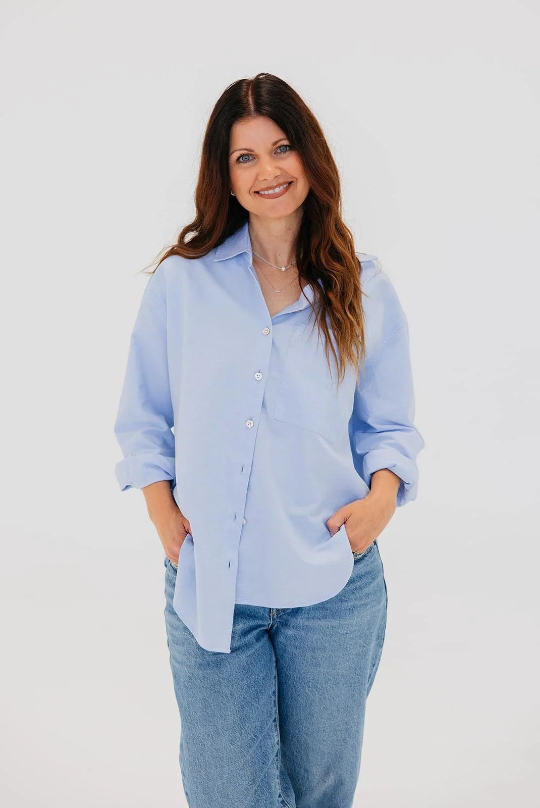 Allison Blackwell standing in a light blue shirt and jeans