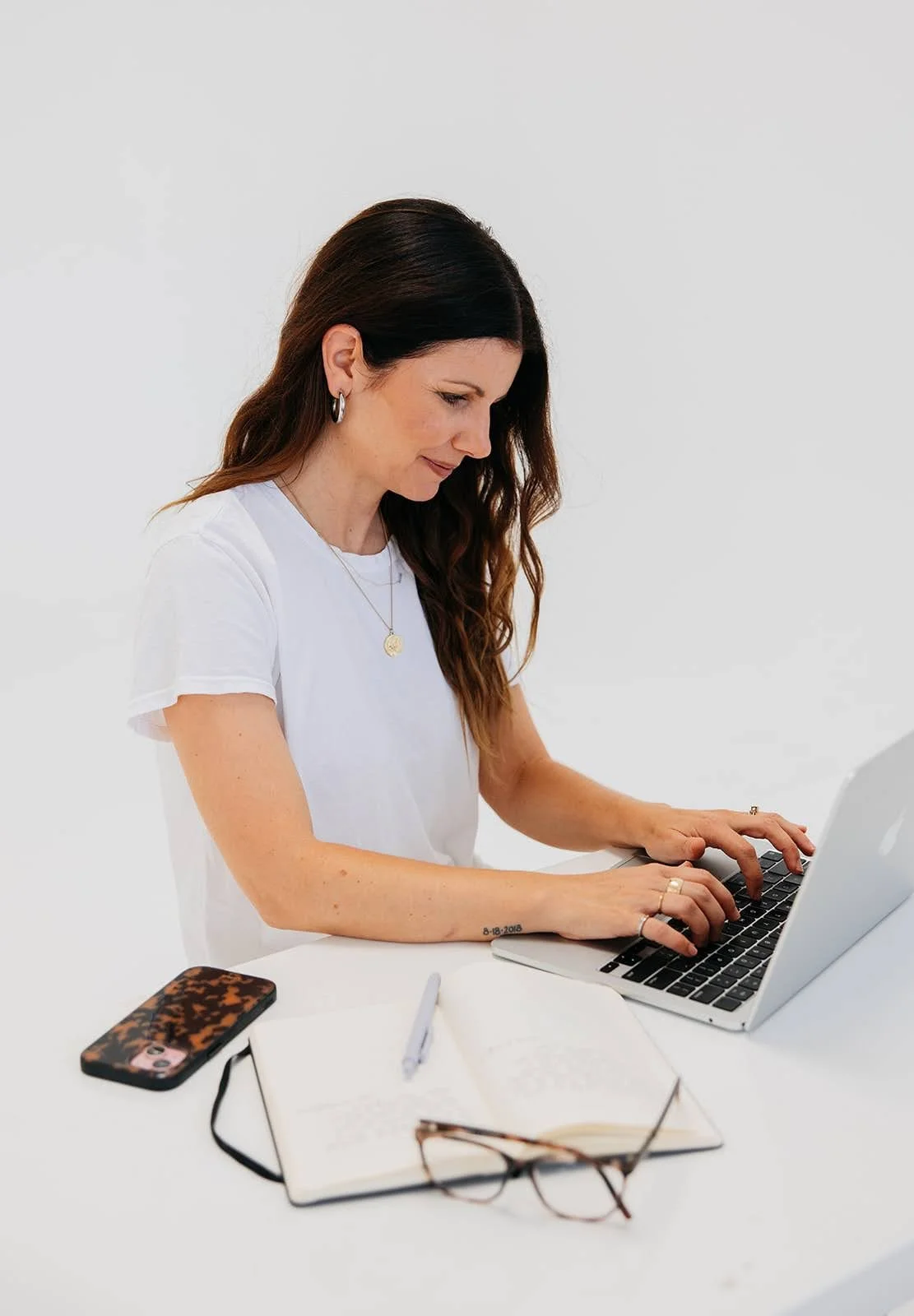 Allison Blackwell working on her laptop at a desk