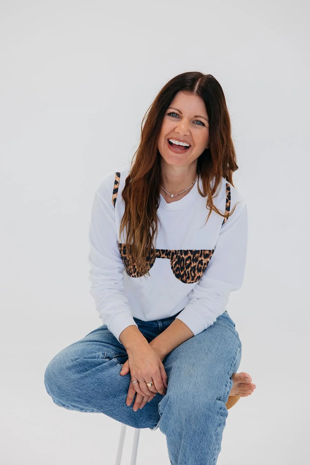 Allison Blackwell smiling while sitting on the floor