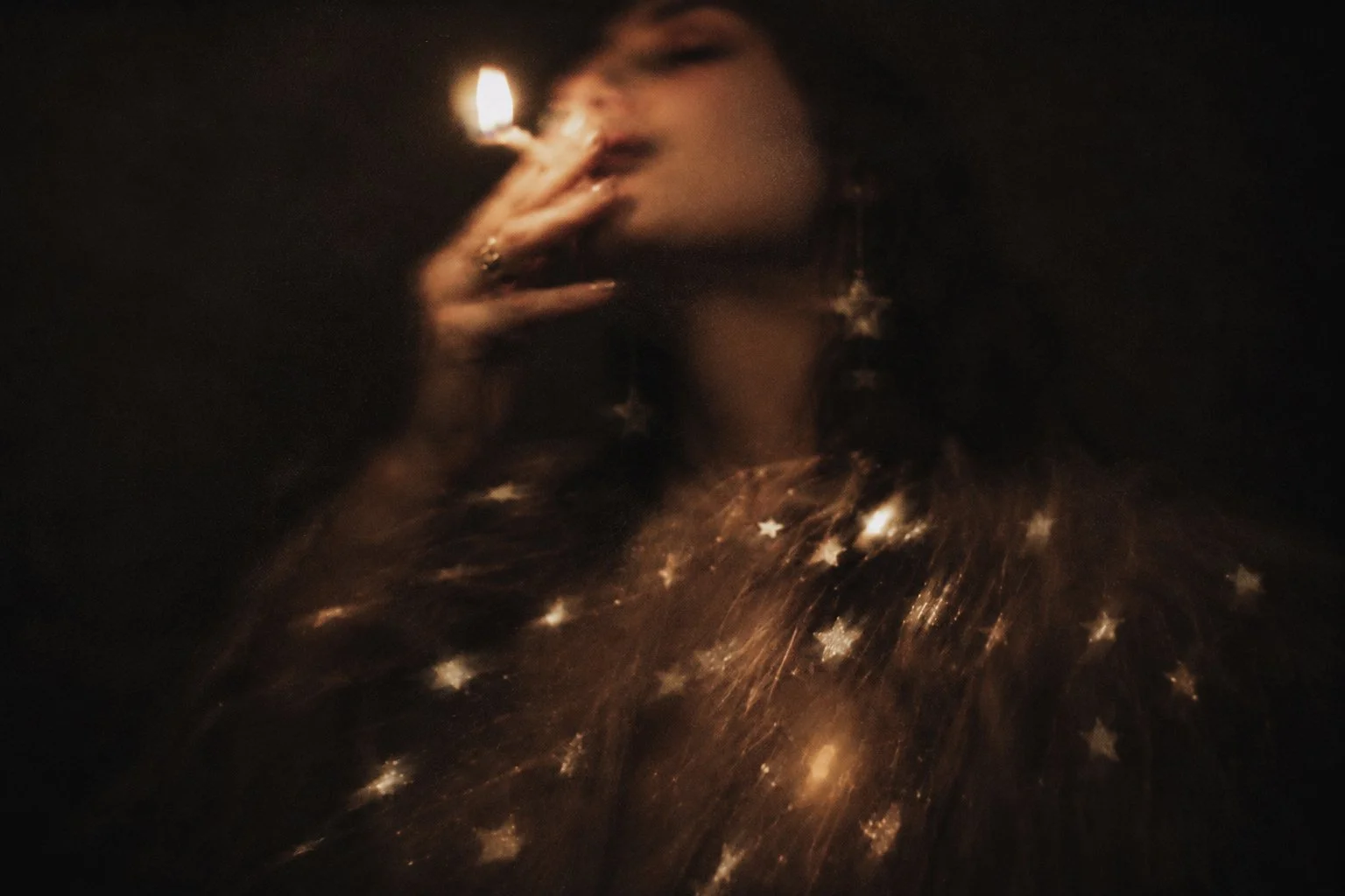 woman-holding-match-starry-background