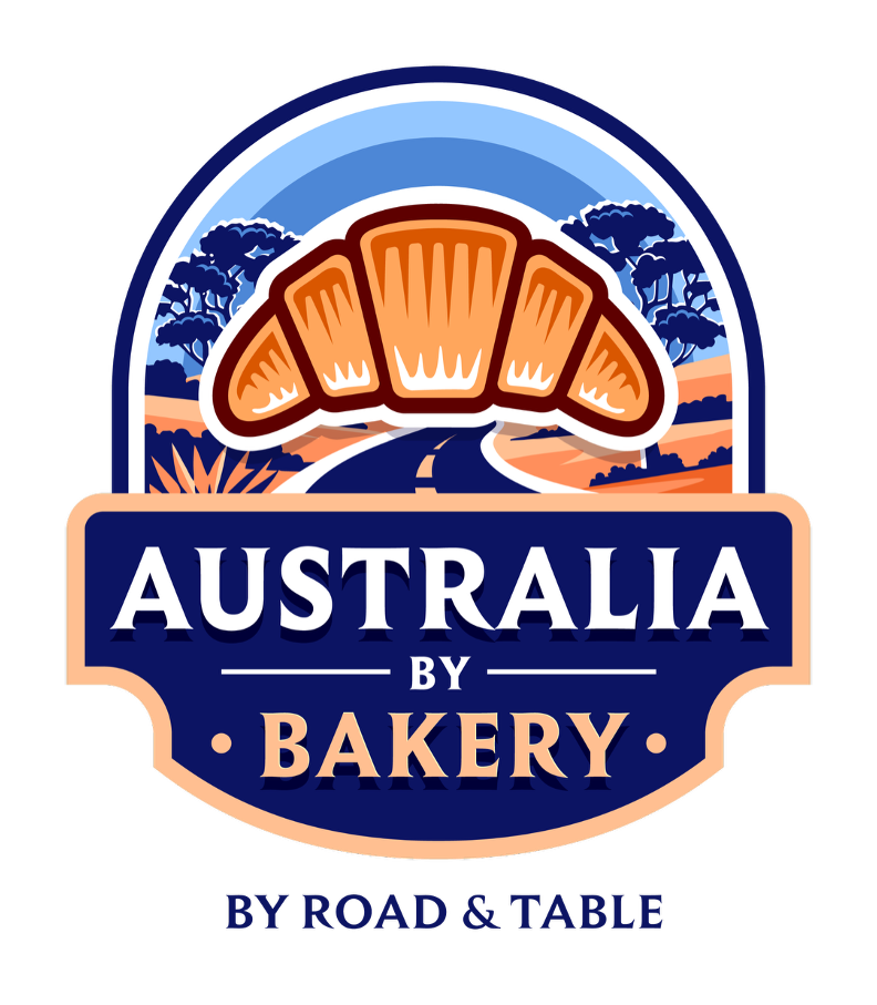 Logo for Australia by Bakery featuring a stylized landscape with trees, a road, and a croissant at the top, with the text 'Australia by Bakery' and 'By Road & Table'.
